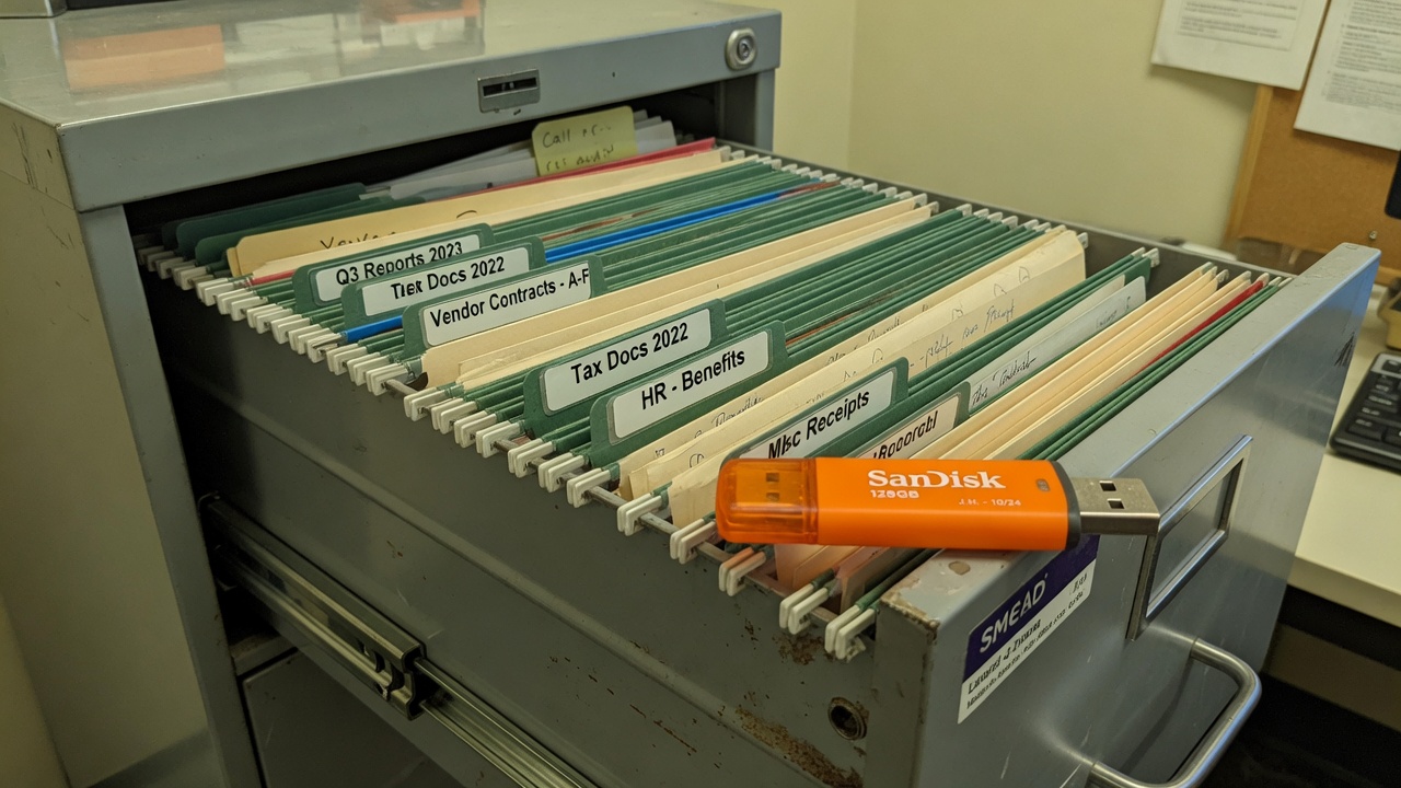 Open file drawer with folders and USB stick